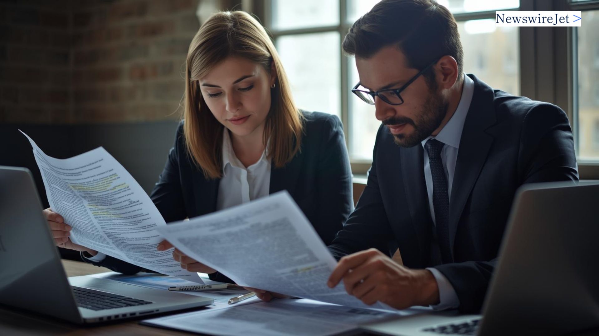 Professionals reviewing documents focused on balancing transparency with legal risk in crisis communications